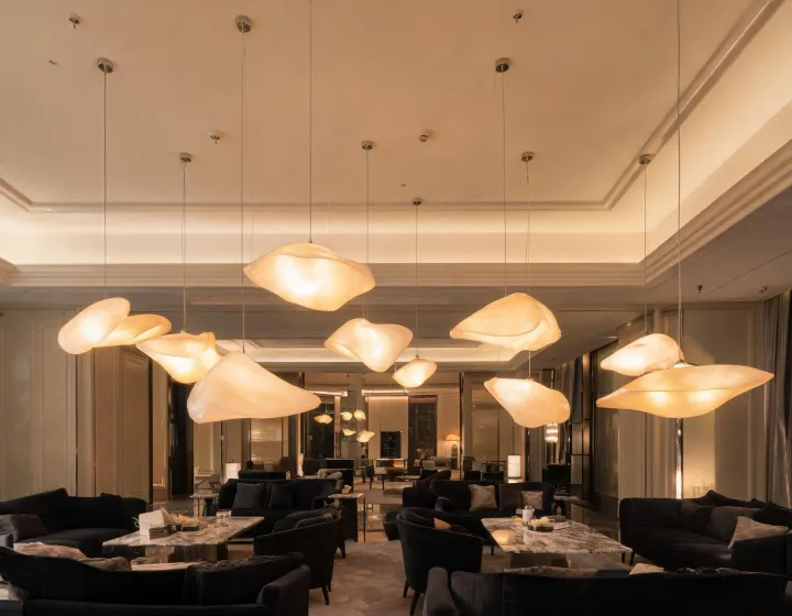 Decorative pendant lighting installed over a hotel lounge